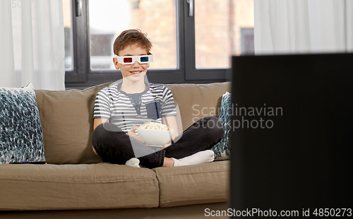 Image of boy in 3d movie glasses and watching tv at home