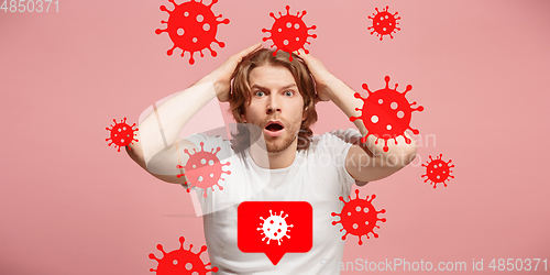 Image of Young man scared of coronavirus spreading and worldwide cases, shocked, keeping quarantine