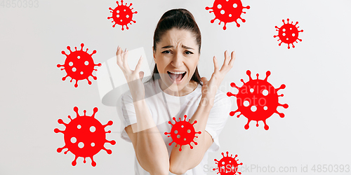 Image of Young woman scared of coronavirus spreading and worldwide cases, shocked, keeping quarantine