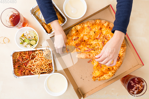 Image of Top view of having sliced of pizza