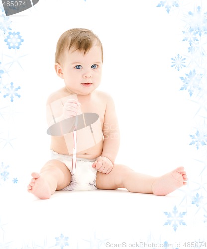 Image of baby boy in diaper with toothbrush