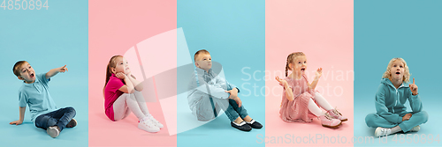 Image of Young and happy kids gesturing isolated on multicolored studio background. Human emotions, facial expression concept