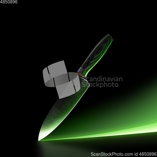 Image of Chef s knife isolated on black studio background with green neon path and copyspace