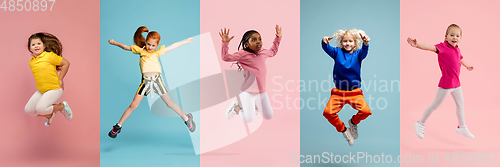 Image of Young and happy kids gesturing isolated on multicolored studio background. Human emotions, facial expression concept