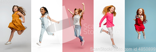 Image of Young and happy kids gesturing isolated on multicolored studio background. Human emotions, facial expression concept
