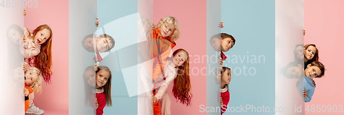 Image of Young and happy kids gesturing isolated on multicolored studio background. Human emotions, facial expression concept