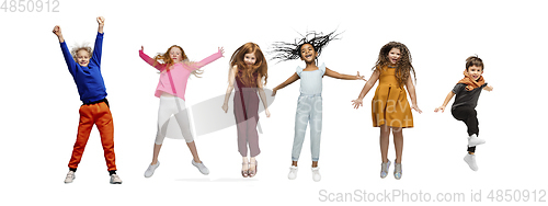 Image of Little and happy kids gesturing isolated on white studio background. Human emotions, facial expression concept