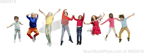 Image of Little and happy kids gesturing isolated on white studio background. Human emotions, facial expression concept