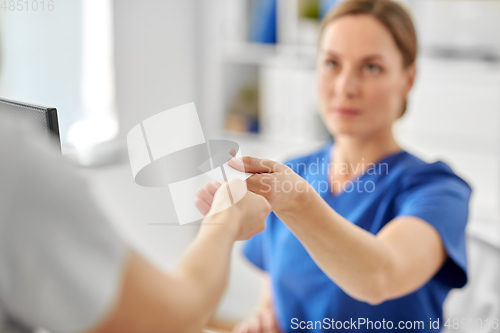 Image of patient giving tag to doctor or nurse at hospital