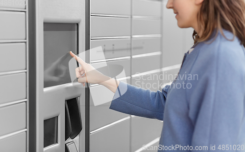 Image of smiling woman using automated parcel machine