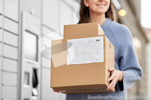 Image of woman with boxes at automated parcel machine