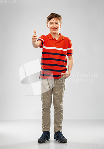 Image of happy boy in red polo t-shirt showing thumbs up