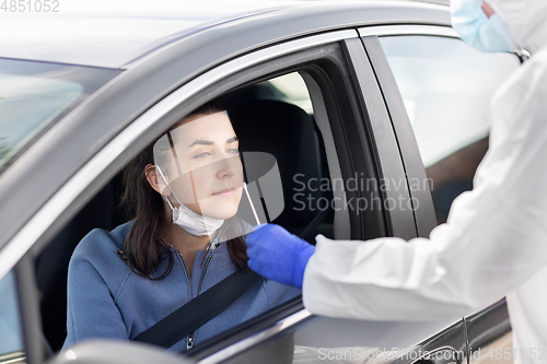 Image of healthcare worker making coronavirus test at car