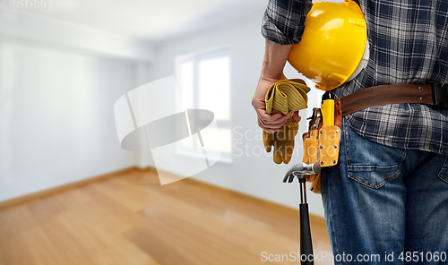 Image of worker or builder with helmet and working tools