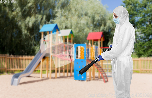 Image of sanitation worker in hazmat with pressure washer