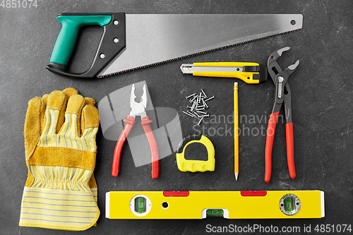 Image of different work tools on slate background