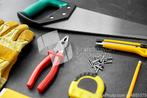 Image of different work tools on slate background