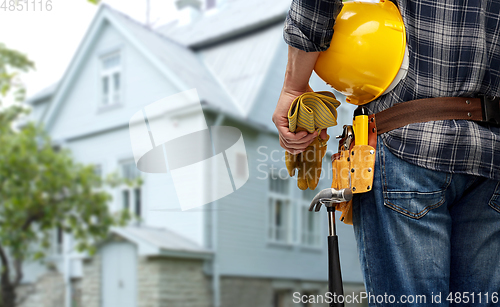 Image of worker or builder with helmet and working tools