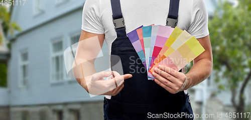 Image of close up of painter with color charts