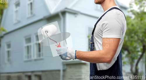 Image of close up of painter or builder with paint roller