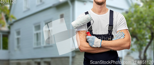 Image of close up of painter or builder with paint roller