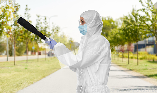 Image of sanitation worker in hazmat with pressure washer