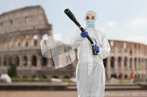 Image of sanitation worker in hazmat with pressure washer