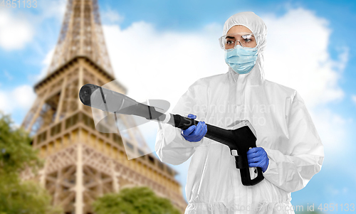 Image of sanitation worker in hazmat with pressure washer