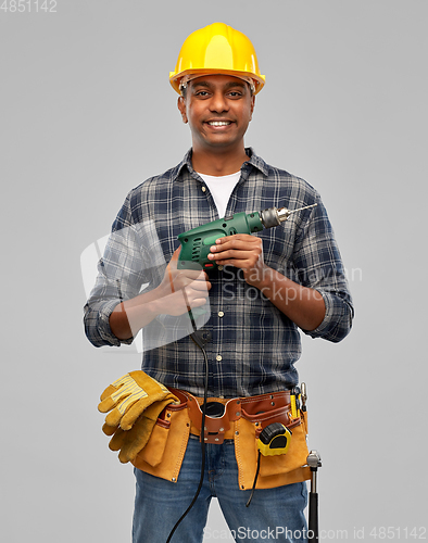 Image of happy indian builder in helmet with electric drill