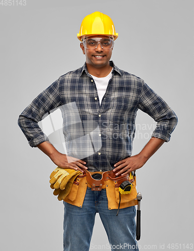 Image of happy indian builder in helmet with tool belt