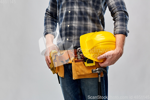 Image of worker or builder with helmet and working tools