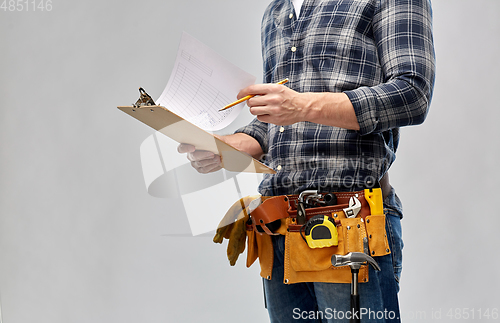 Image of builder with clipboard, pencil and working tools