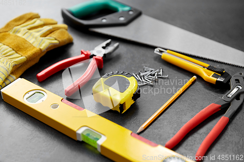 Image of different work tools on slate background