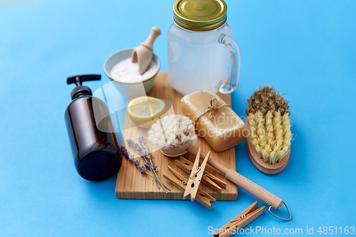 Image of washing soda, soap, brushes, lemon and clothespins