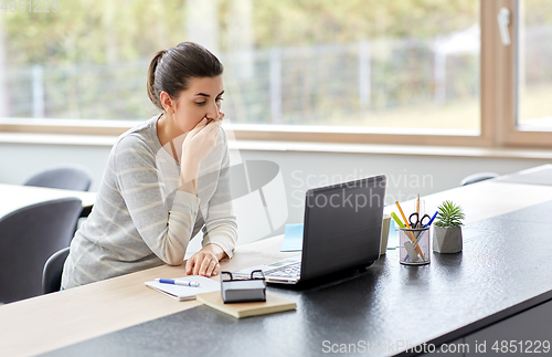 Image of woman with laptop working at home office