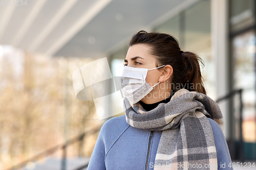 Image of young woman wearing protective medical mask