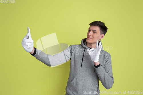 Image of Caucasian man\'s portrait isolated on yellow studio background - freaky model