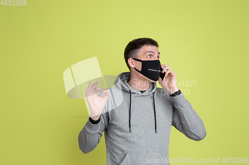 Image of Caucasian man\'s portrait isolated on yellow studio background - freaky model