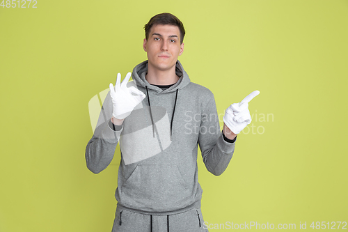 Image of Caucasian man\'s portrait isolated on yellow studio background - freaky model