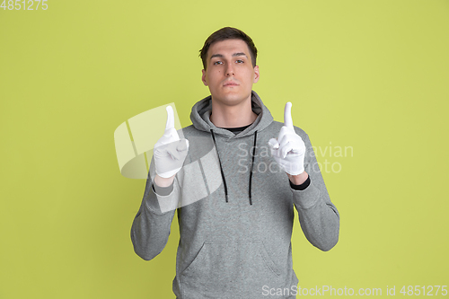 Image of Caucasian man\'s portrait isolated on yellow studio background - freaky model