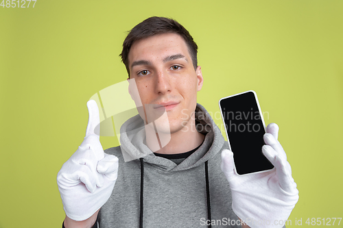 Image of Caucasian man\'s portrait isolated on yellow studio background - freaky model