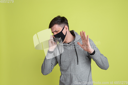 Image of Caucasian man\'s portrait isolated on yellow studio background - freaky model