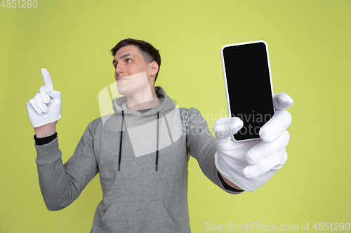 Image of Caucasian man\'s portrait isolated on yellow studio background - freaky model