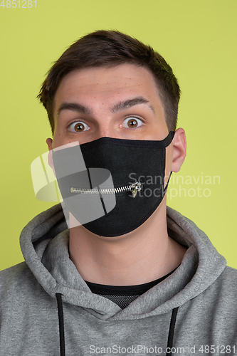 Image of Caucasian man\'s portrait isolated on yellow studio background - freaky model