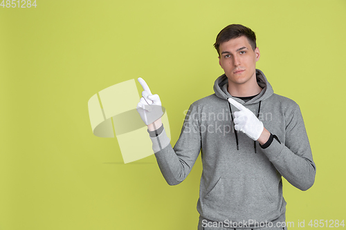 Image of Caucasian man\'s portrait isolated on yellow studio background - freaky model