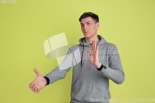 Image of Caucasian man\'s portrait isolated on yellow studio background - freaky model