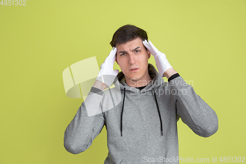 Image of Caucasian man\'s portrait isolated on yellow studio background - freaky model