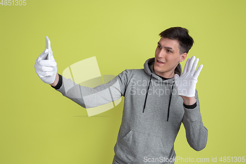 Image of Caucasian man\'s portrait isolated on yellow studio background - freaky model