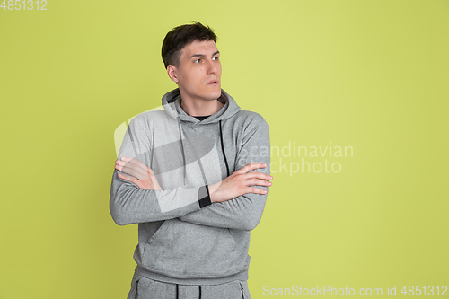 Image of Caucasian man\'s portrait isolated on yellow studio background - freaky model