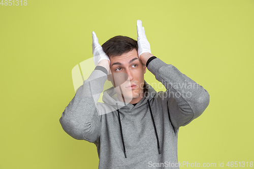 Image of Caucasian man\'s portrait isolated on yellow studio background - freaky model